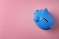 Blue piggy bank on color background, Royalty Free Stock Photo