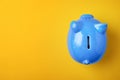 Blue piggy bank on color background Royalty Free Stock Photo