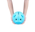 Blue piggy bank or colorful empty money savings box and asian little   child hand holding isolated on white background with Royalty Free Stock Photo