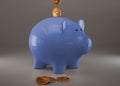 Blue piggy bank with cryptocurrencies, golden physical coins, Ripple, Zcoin, Bitcoin and Etherium. Mining cryptocurrency