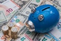 Blue Piggy Bank with Euros, Dollars and Pound coins.