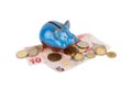 Blue piggy bank and Turkish currency, isolated