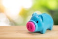 Blue piggy bank on wooden table Royalty Free Stock Photo