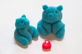 Blue piggy figure made from play dough and heart-shaped candles Royalty Free Stock Photo