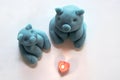 Blue piggy figure made from play dough and heart-shaped candles Royalty Free Stock Photo