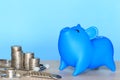 Blue piggy with thermometer and Stack of coins money on blue background,Save money for Medical expenses and Health care concept Royalty Free Stock Photo