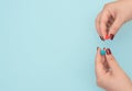 Blue pill on female hand on blue background. Seasonal diseases. Right choice, medicine concept. Flat lay style with copy space