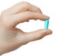 Blue pill in hand on a white background. Isolate on a white background. Royalty Free Stock Photo