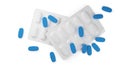 Blue pill tablets scattered over two white pill blister packs isolated on white background flat lay top view from above, medicine