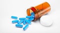 Blue pills with bottle on white background Royalty Free Stock Photo