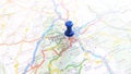 A blue pin stuck in Clermont Ferrand on a map of France