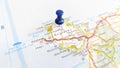 A blue pin stuck in the island of Anglesey on a map Royalty Free Stock Photo