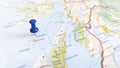 A blue pin stuck in the island of colonsay on a map of Scotland Royalty Free Stock Photo