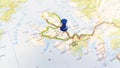 A blue pin stuck in the island of sky on a map of Scotland