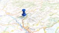 A blue pin stuck in Lake Iseo on a map of Italy