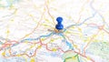 A blue pin stuck in Nimes on a map of France