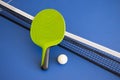 Blue ping pong table. Green Ping pong racket and ball. The concept of sport and healthy lifestyle. Table tennis Royalty Free Stock Photo