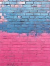 Blue and pink brick wall with colorful graffiti design. Royalty Free Stock Photo