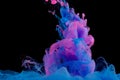 Blue and pink clouds of ink in liquid on black Royalty Free Stock Photo