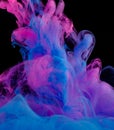 Blue and pink clouds of ink in liquid isolated on black Royalty Free Stock Photo