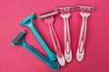 Blue and pink female razor on a pink background