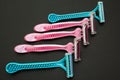 Blue and pink female razor on a black background