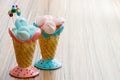 Blue and pink meringue in the pink and blue cones with cupcakes on wood background or happy mothers day Royalty Free Stock Photo