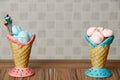 Blue and pink meringue in the pink and blue cones with cupcakes on wood table white background Royalty Free Stock Photo