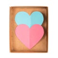 Blue and pink paper hearts in open cardboard box isolated on white background Royalty Free Stock Photo