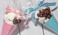 Blue and pink presents of sweets and marshmallows packed in cones