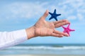 Blue and pink Star fishes in hand business man