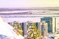 Blue and pink sunset sky over the frozen river in winter on the horizon with high-rise residential buildings, Royalty Free Stock Photo