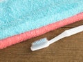 The blue and pink towel with white toothbrush Royalty Free Stock Photo