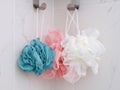Blue, pink and white shower scrubbers