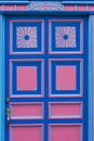 Blue and pink wooden window of a colonial house front in Salento, Colombia Royalty Free Stock Photo