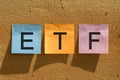 Blue, pink and yellow note paper write the text ETF. Stick on the well. Concept Efforts to enter the digital currency