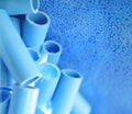 Blue pipe and plastic polymer pellets raw material for blue pvc pipe production. Industrial plastic resin. Chemical polymer Royalty Free Stock Photo