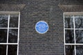 Blue Plaque on the wall of the former house of William Butterfield, London, UK.