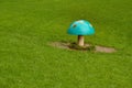 Blue plastic amanita muscaria mushroom on a green lawn. Royalty Free Stock Photo