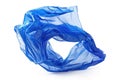 A blue plastic bag lying on a white surface Royalty Free Stock Photo