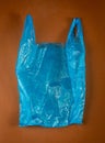 Blue Plastic Bags on Brown Background, Crumpled Plastic Bag after Shopping, Cellophane Packaging Waste
