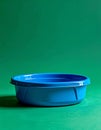 Blue Plastic Basin on a Green Background Royalty Free Stock Photo