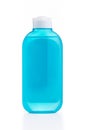 The blue plastic bottle with blue empty label isolated on white Royalty Free Stock Photo