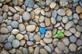 Blue plastic bottle cap on pebbles, Environmental pollution problem concept Royalty Free Stock Photo