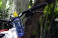 A blue plastic bottle water and mountain bike on natural background