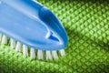 Blue plastic brush on green dishcloth Royalty Free Stock Photo