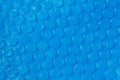 Blue plastic bubble wrap texture.