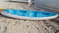 Blue plastic canoe boat pulled ashore at the beach Royalty Free Stock Photo