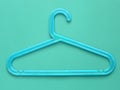 Blue plastic cloth hanger on blue background Royalty Free Stock Photo