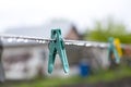 Blue plastic clothespin with raindrop. Rainy weather. Royalty Free Stock Photo